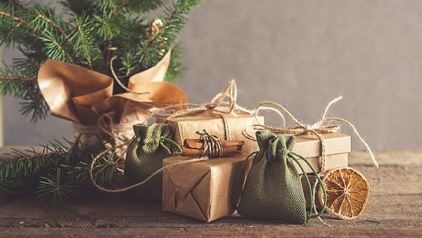 NAchhaltige Weihnachten: Mehrere kleine Geschenke in ökologischer Verpackung stehen auf einem Gabentisch.